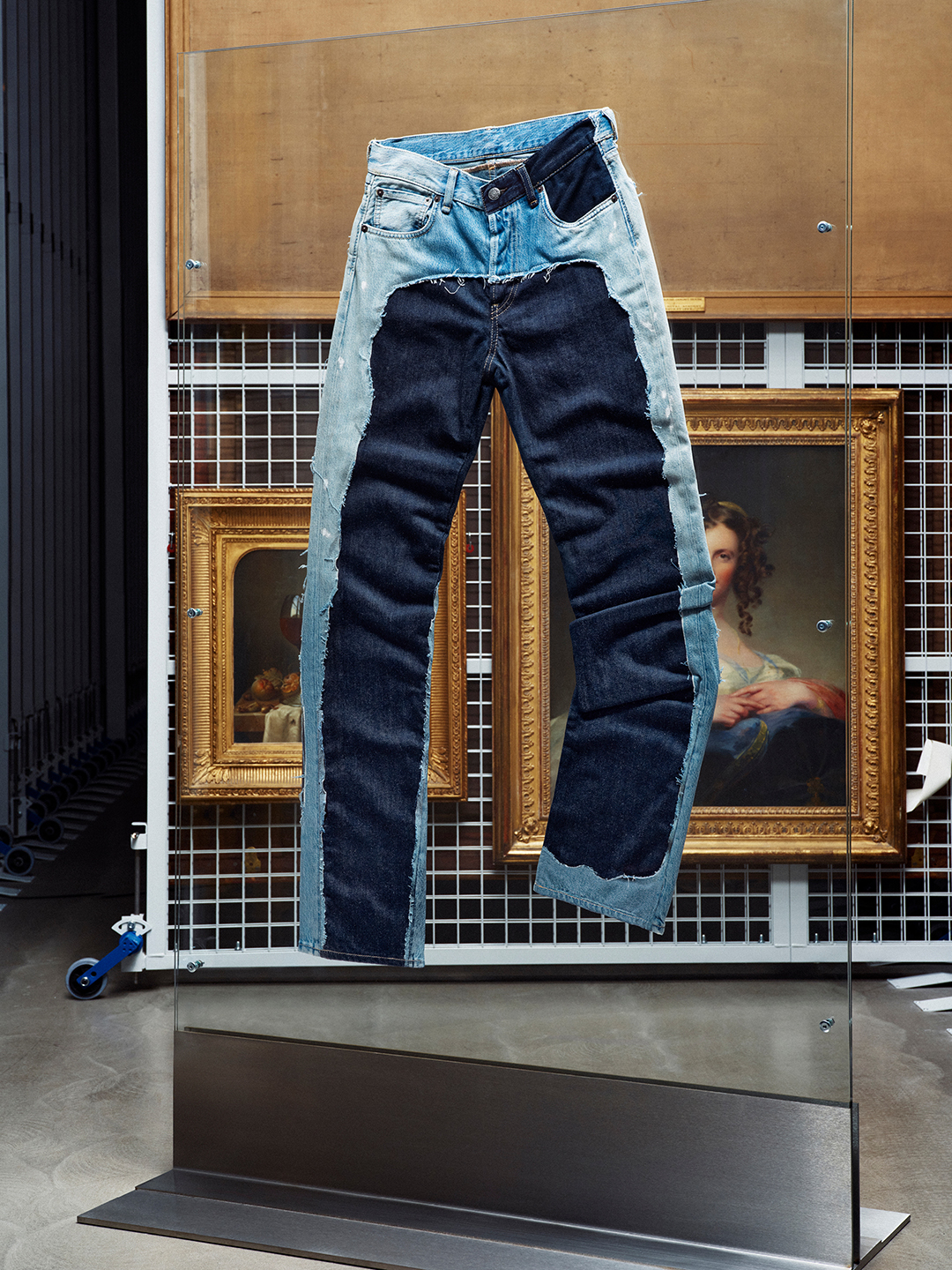 Acne Studios x Hussein Chalayan asymmetrical denim dress photographed among V&A museum archive racks